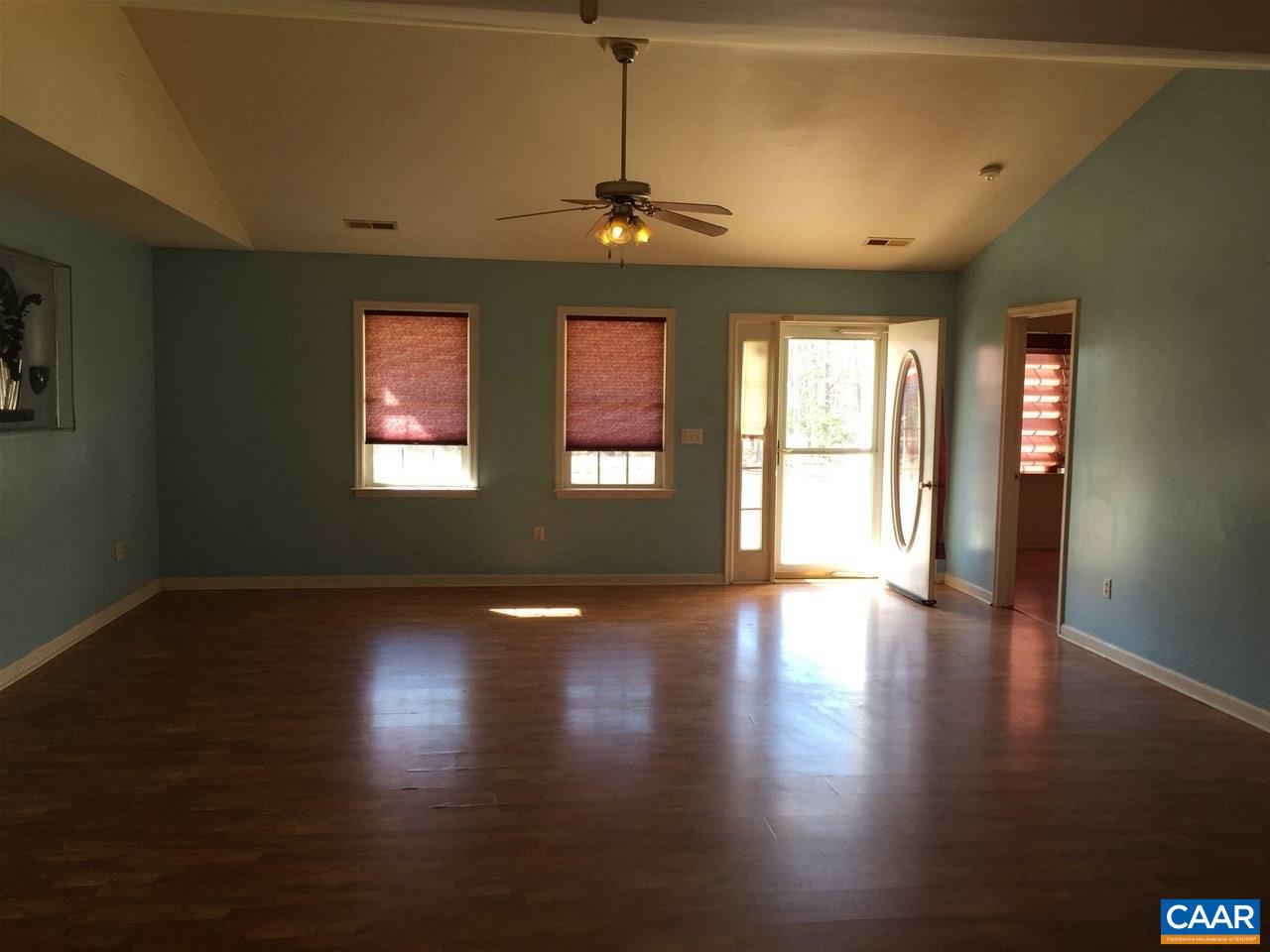 550 Walnut Shade Road Louisa, VA 23093 - Photo 8 of 28 a view of an empty room with wooden floor and a window