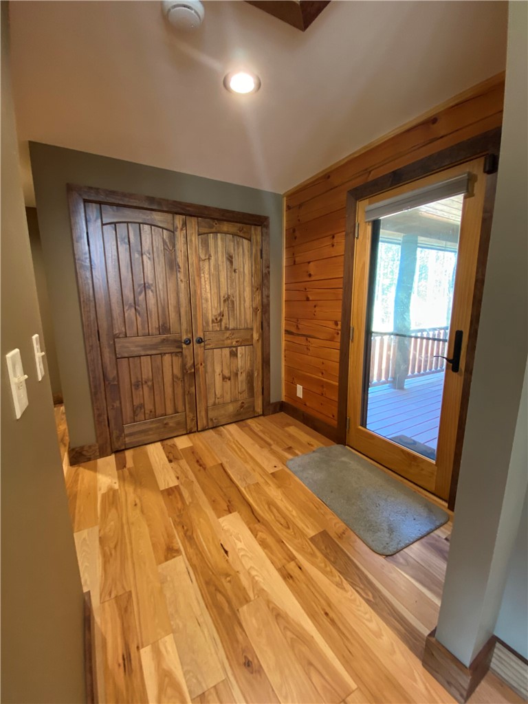 128 McAlister Road West Union, SC 29696 - Photo 27 of 40 Natural wood flooring complements rustic barn doors, leading to an inviting outdoor space.