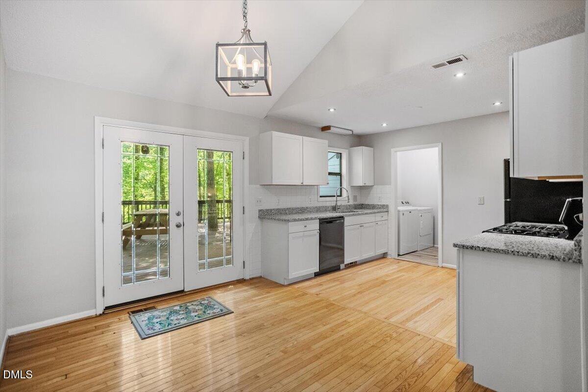 1405 Fairway Ridge Drive Raleigh, NC 27606 - Photo 13 of 27 a kitchen with stainless steel appliances granite countertop a stove a sink dishwasher and a refrigerator with wooden floor