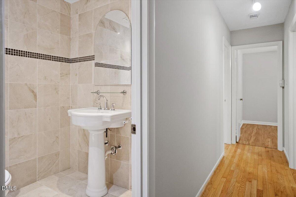 1405 Fairway Ridge Drive Raleigh, NC 27606 - Photo 17 of 27 a bathroom with a sink and shower