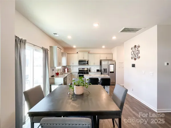 a view of a dining room with furniture and a window