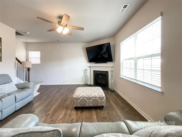 a living room with furniture fireplace and flat screen tv