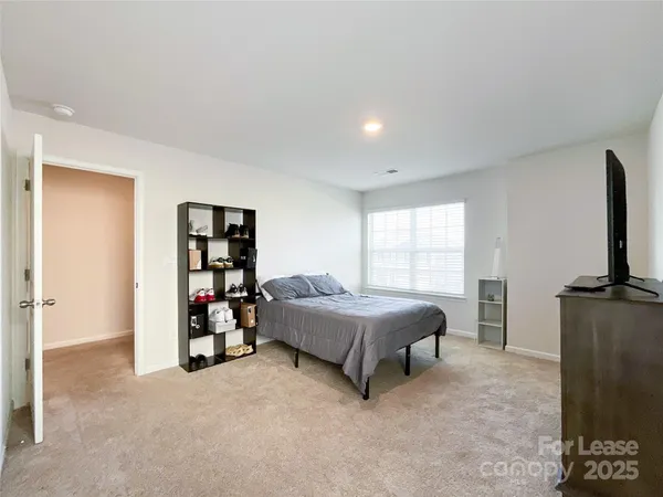 a living room with a bed and a flat screen tv