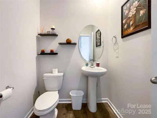 a bathroom with a toilet a sink and mirror