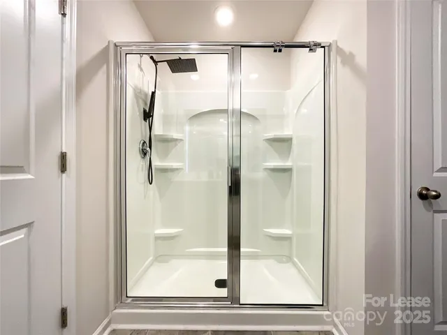 a bathroom with a glass shower door