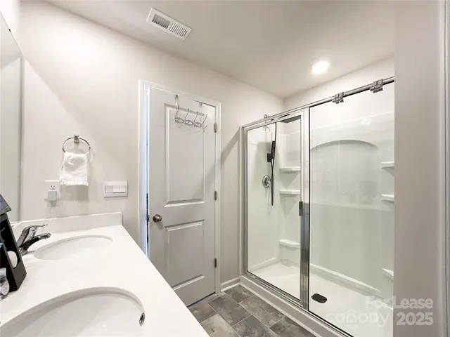 a bathroom with a sink and shower