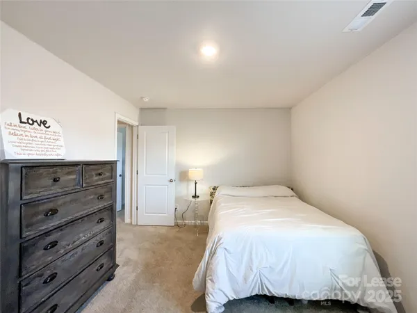 a bedroom with a bed and a mirror