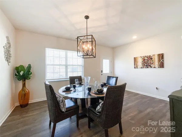 a dining room with furniture potted plants