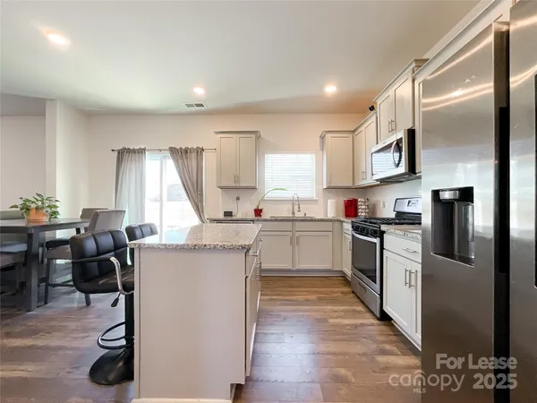 a kitchen with cabinets and window