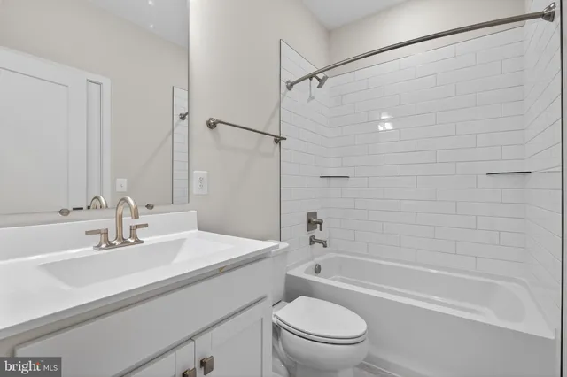 a bathroom with a sink mirror toilet and bathtub