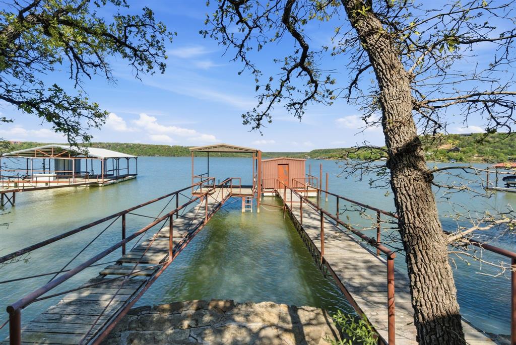 330 Chism Trail Gordon, TX 76453 - Photo 18 of 35 a view of swimming pool with a table and chairs under an umbrella