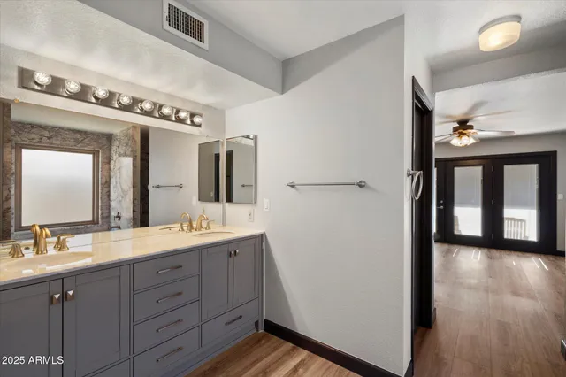 a spacious bathroom with a double vanity sink and a mirror