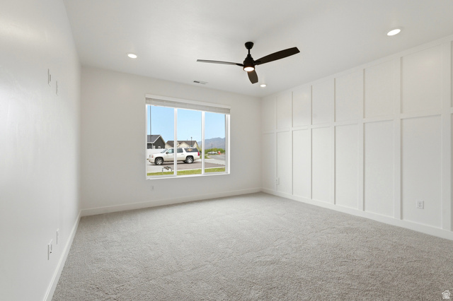 401 West 3085 South, Unit 329 Nibley, UT 84321 - Photo 20 of 34 Spare room with light carpet, a ceiling fan, a decorative wall, and recessed lighting