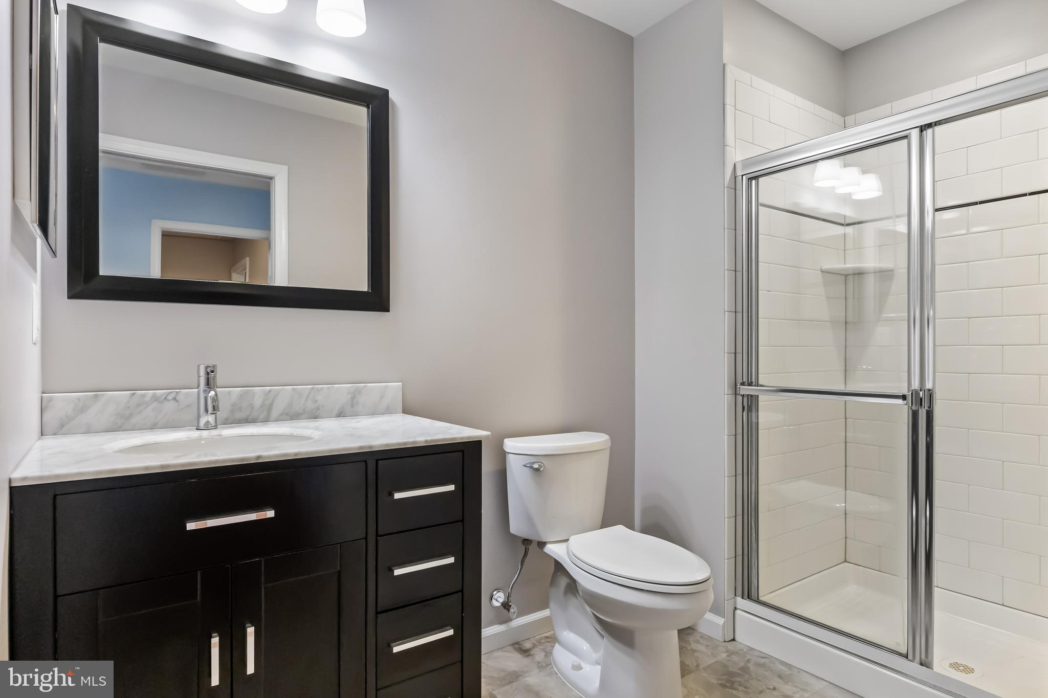 5105 Halifax Way Mount Laurel, NJ 08054 - Photo 18 of 26 a bathroom with a toilet a sink and mirror
