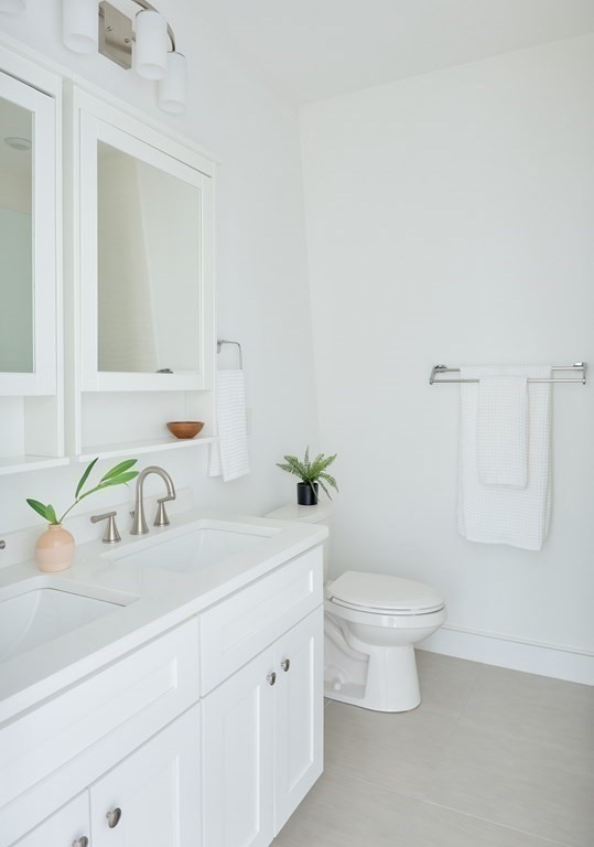 42 Bow Street, Unit 2 Somerville, MA 02143 - Photo 11 of 14 a bathroom with a sink a toilet and a mirror
