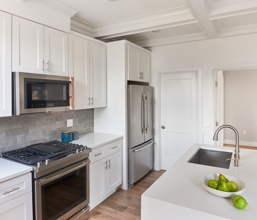 42 Bow Street, Unit 2 Somerville, MA 02143 - Photo 5 of 14 a kitchen with sink a stove and refrigerator