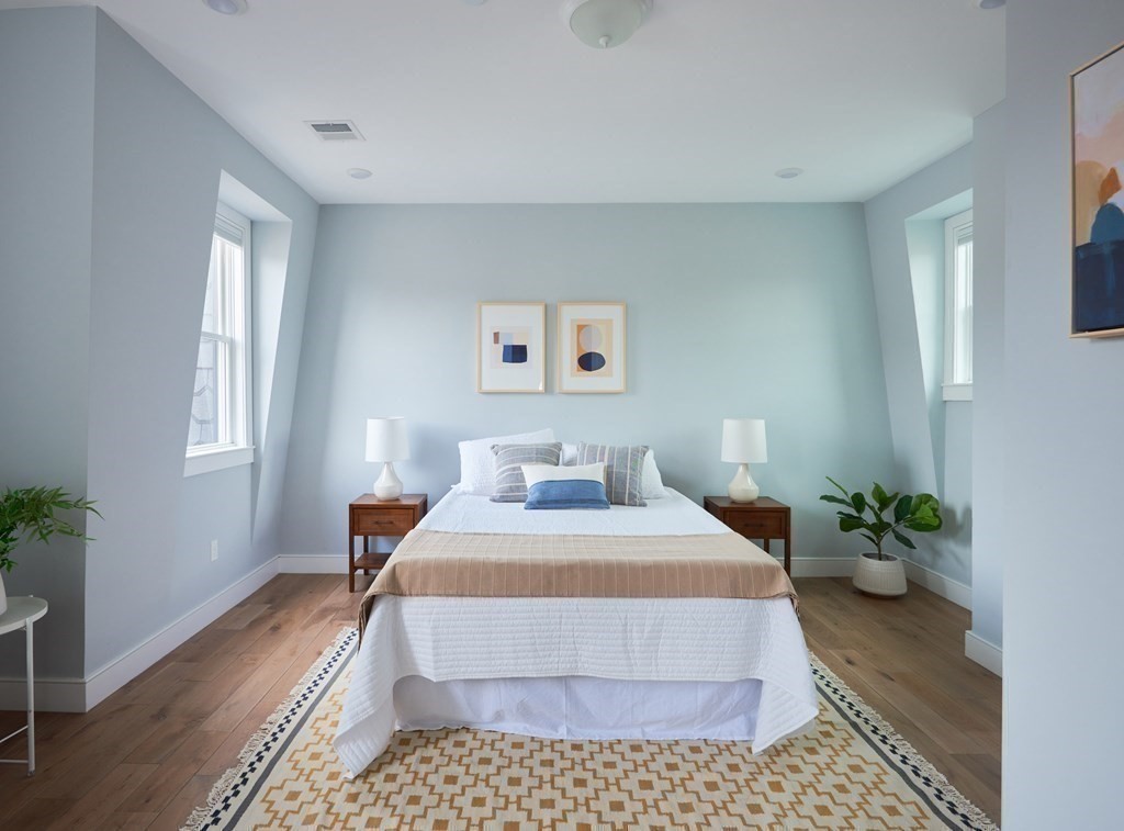 42 Bow Street, Unit 2 Somerville, MA 02143 - Photo 9 of 14 a bedroom with a bed potted plant with the wooden floor