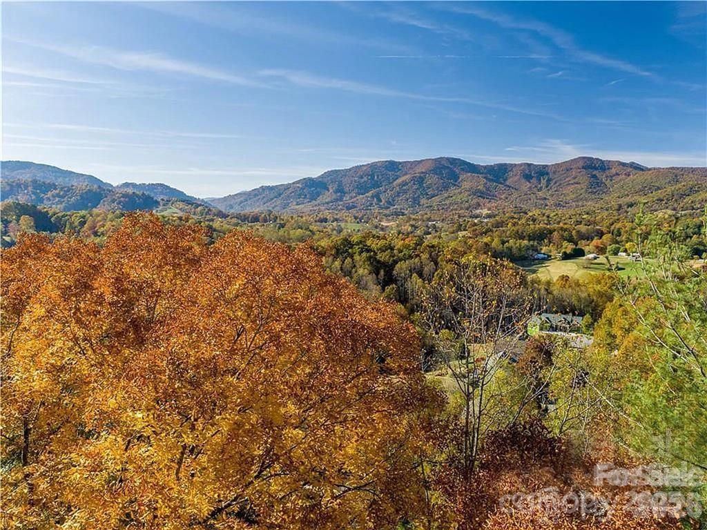 75 South Lindon Cove Road Candler, NC 28715 - Photo 3 of 15 a view of a mountain range in a cloudy sky