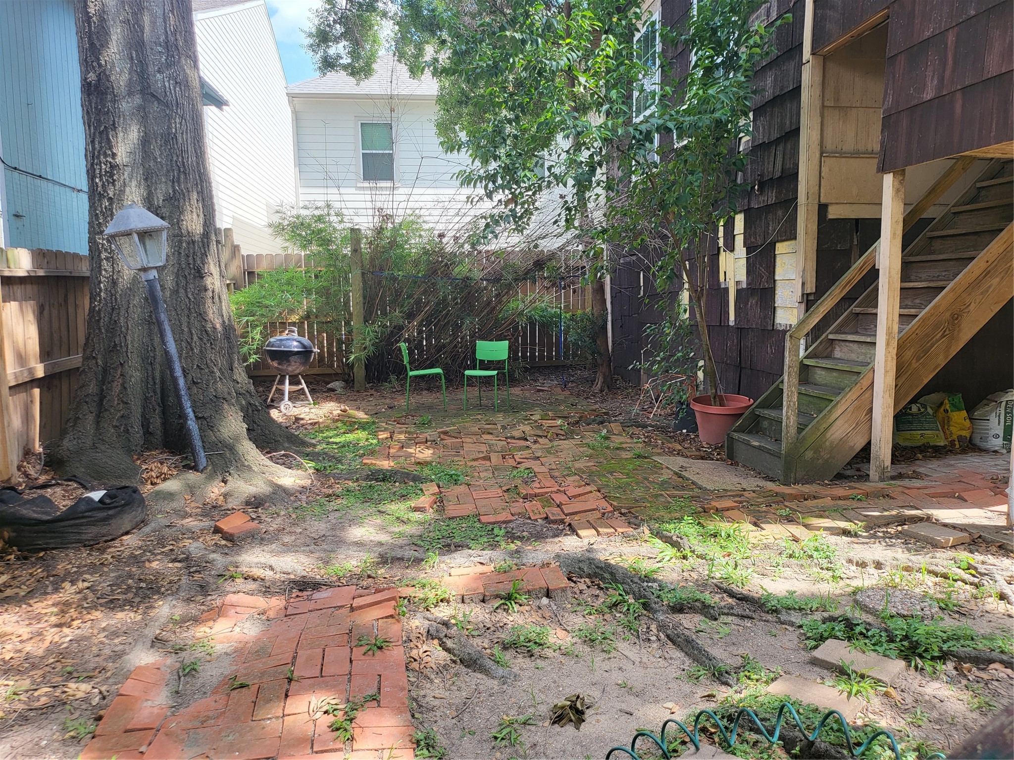 1529 Welch Street Houston, TX 77006 - Photo 16 of 34 a view of a backyard with plants and chairs