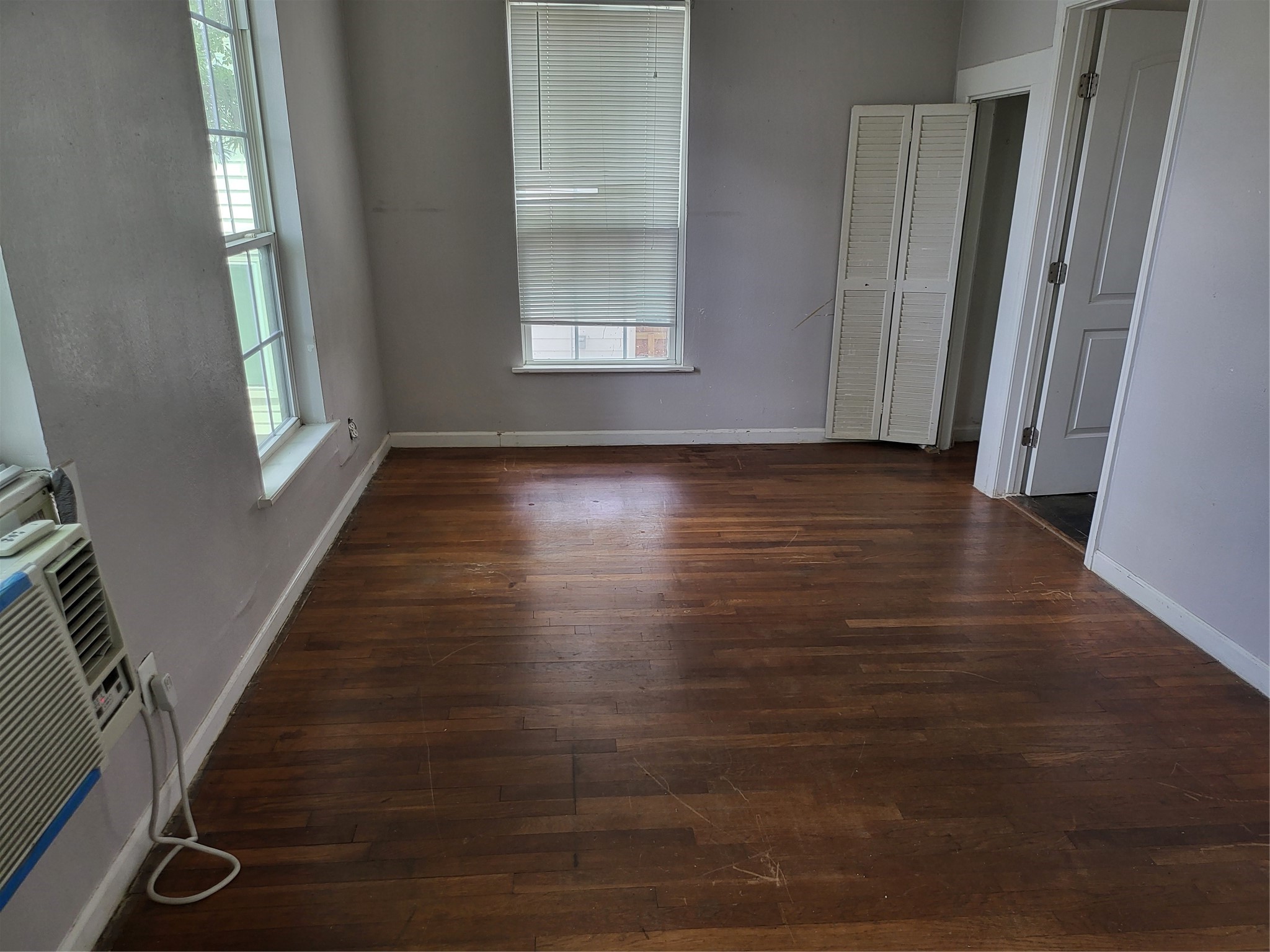 1529 Welch Street Houston, TX 77006 - Photo 26 of 34 a view of an empty room with wooden floor and a window