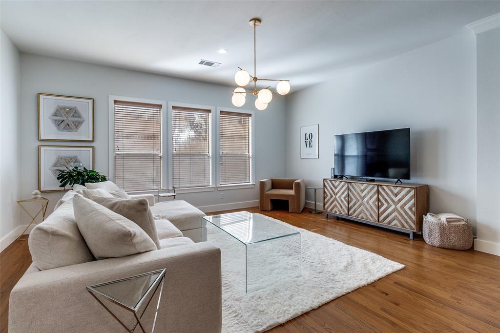 a living room with furniture ceiling fan and a flat screen tv