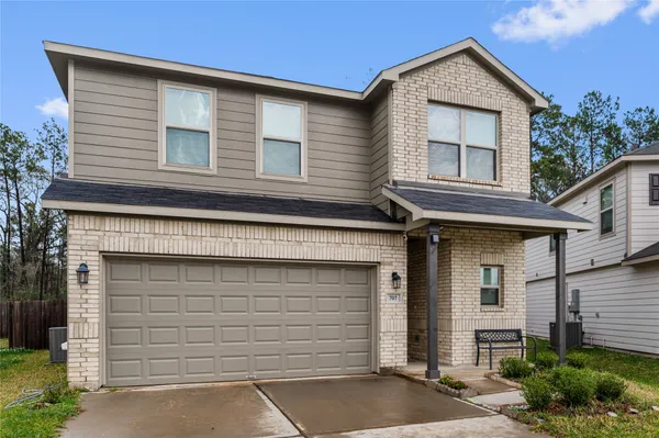 a kitchen with a refrigerator and white cabinets