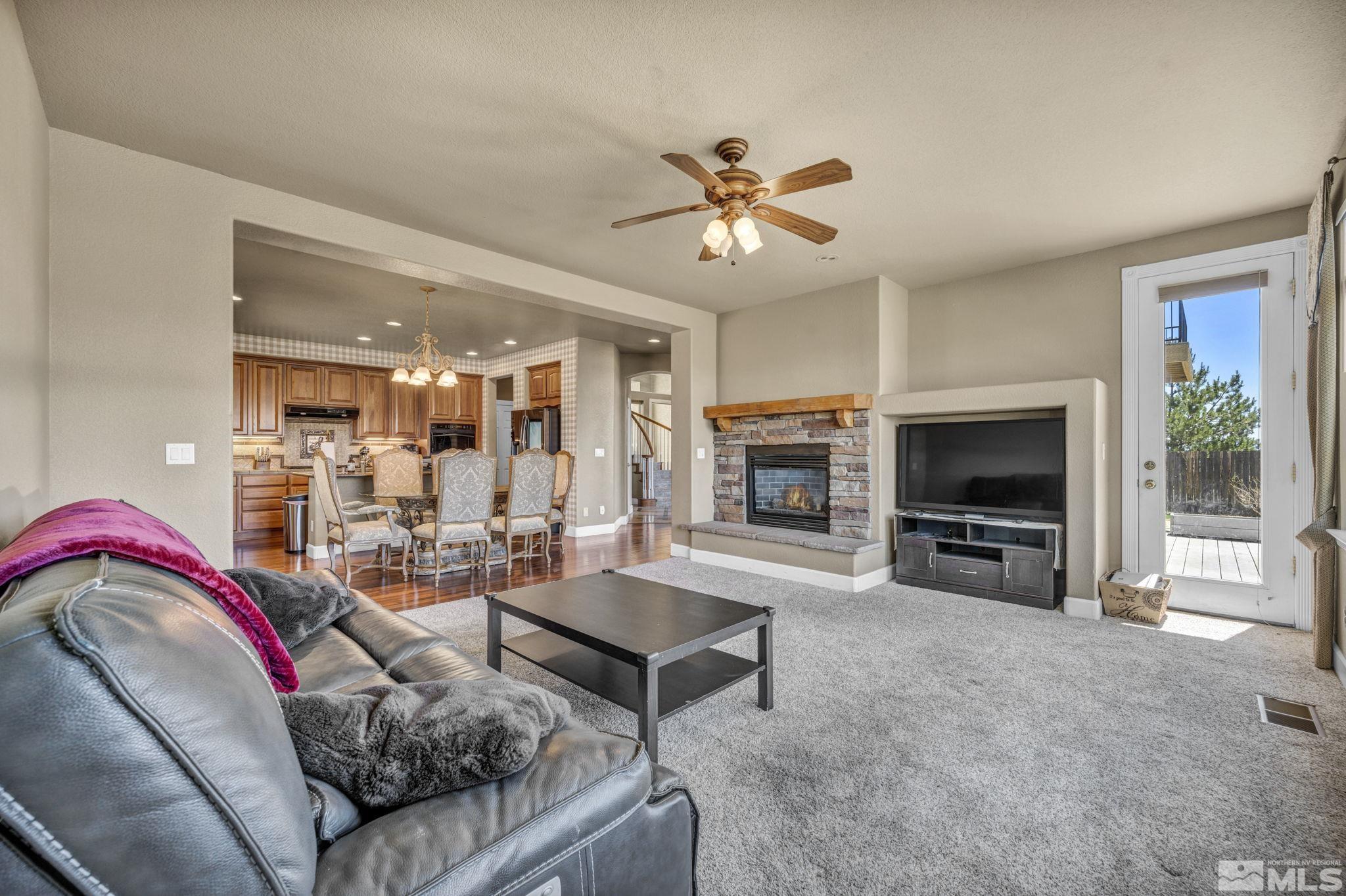 2713 Robb Drive Reno, NV 89523 - Photo 25 of 39 a living room with furniture a flat screen tv and a fireplace