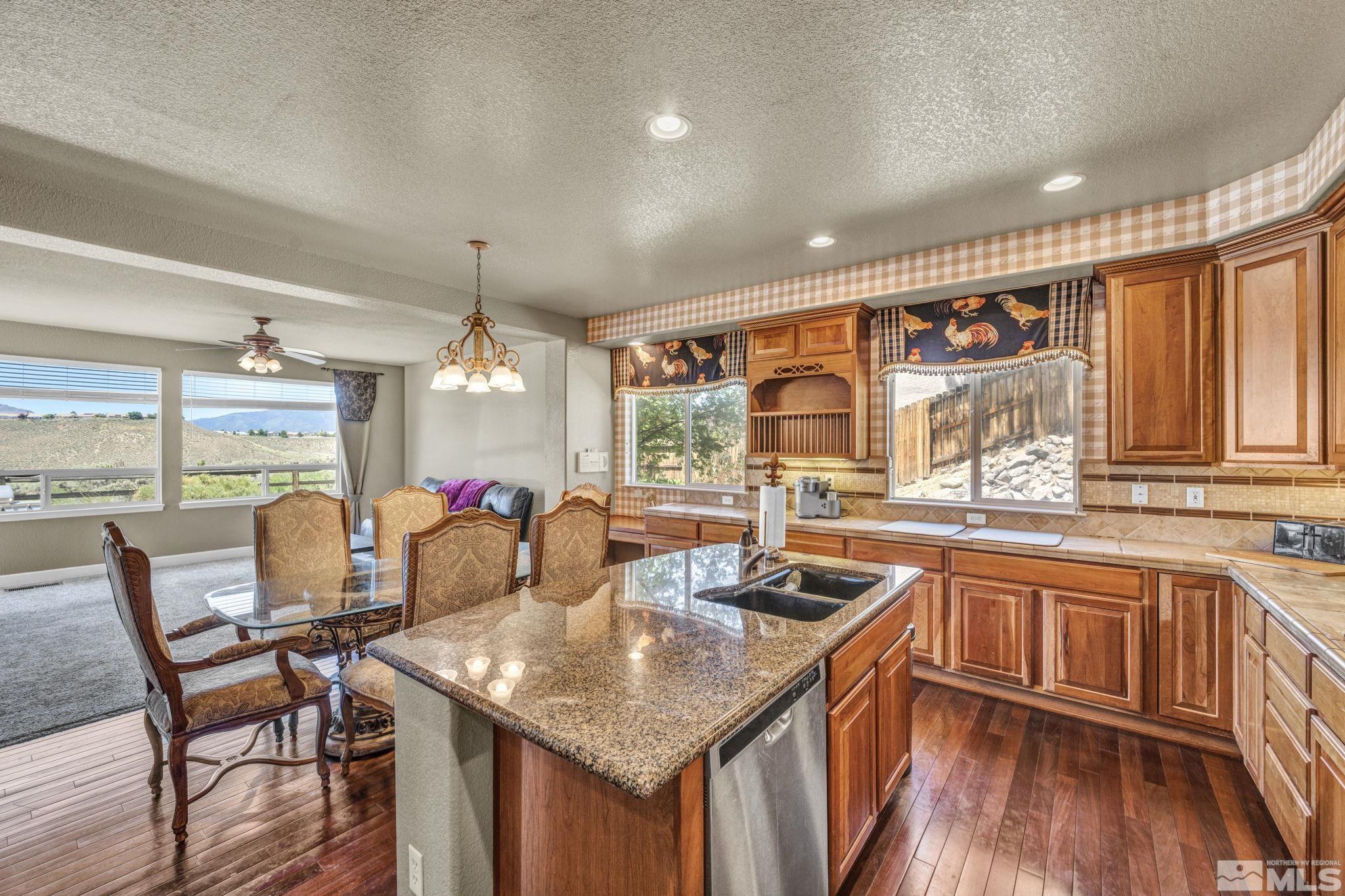 2713 Robb Drive Reno, NV 89523 - Photo 3 of 39 a kitchen with stainless steel appliances granite countertop a sink and chairs