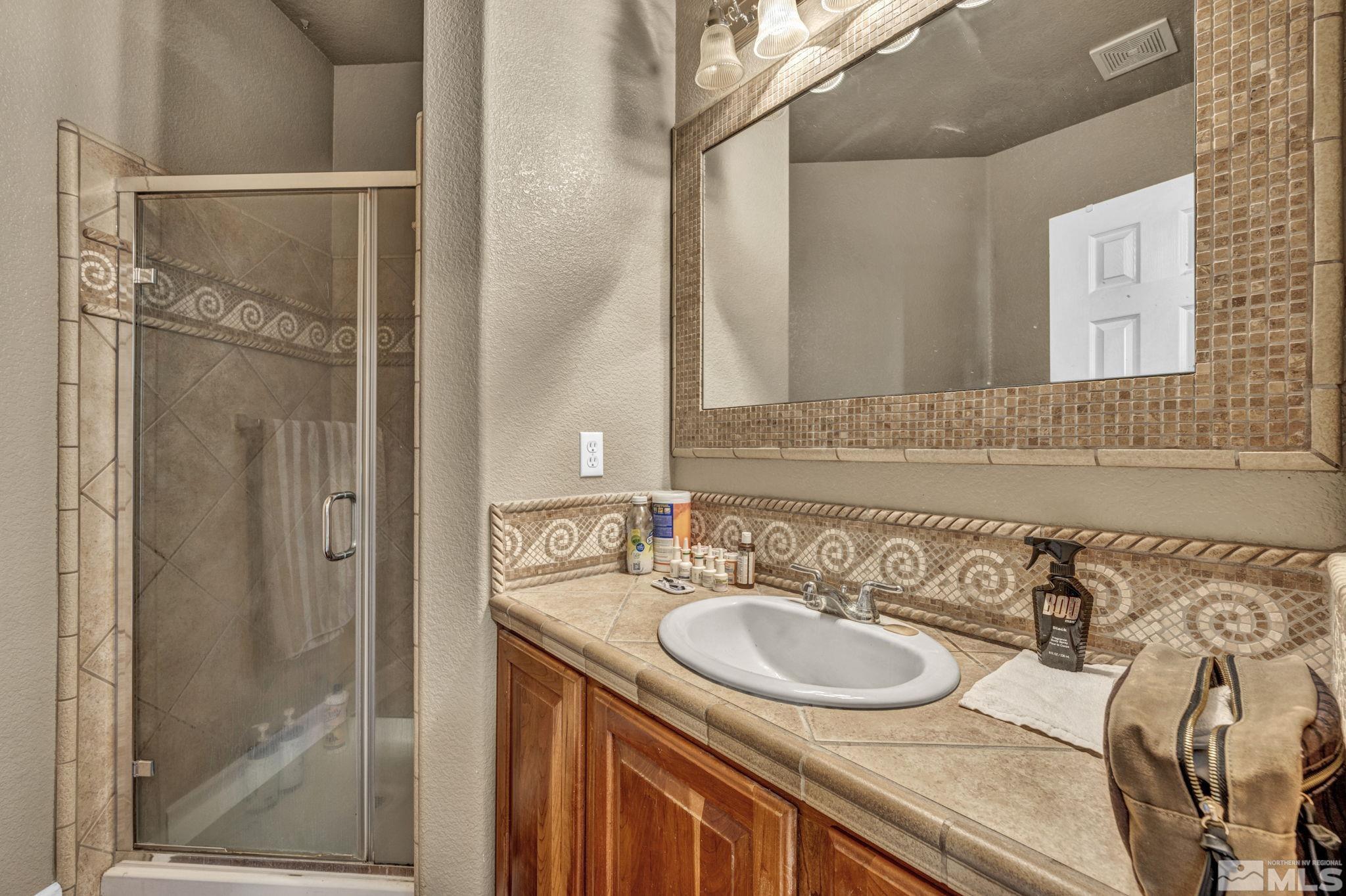 2713 Robb Drive Reno, NV 89523 - Photo 33 of 39 a bathroom with a sink and a mirror