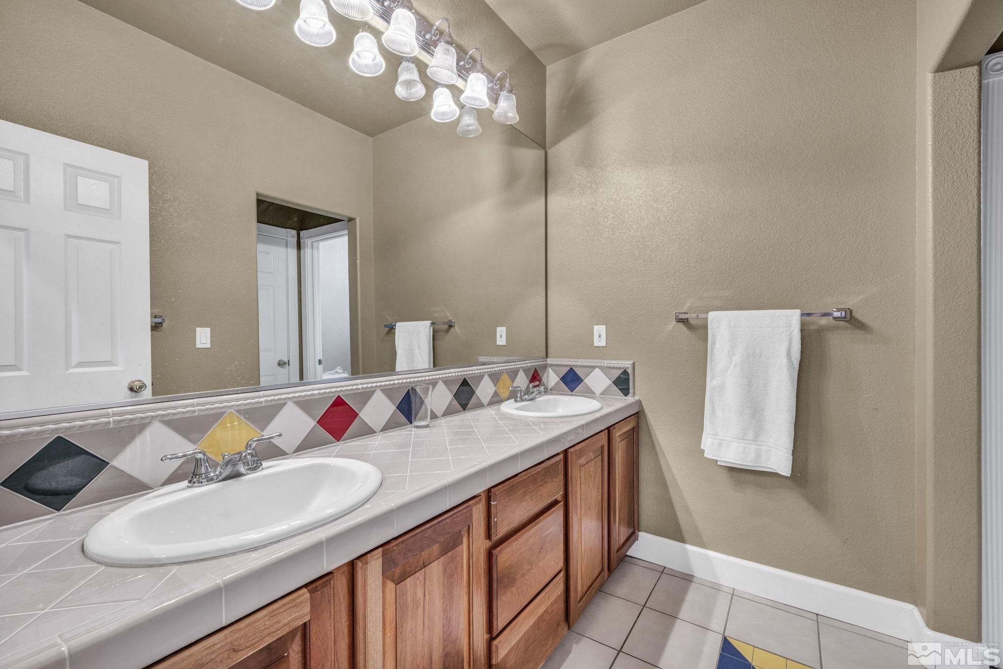 2713 Robb Drive Reno, NV 89523 - Photo 35 of 39 a bathroom with a sink vanity and a mirror