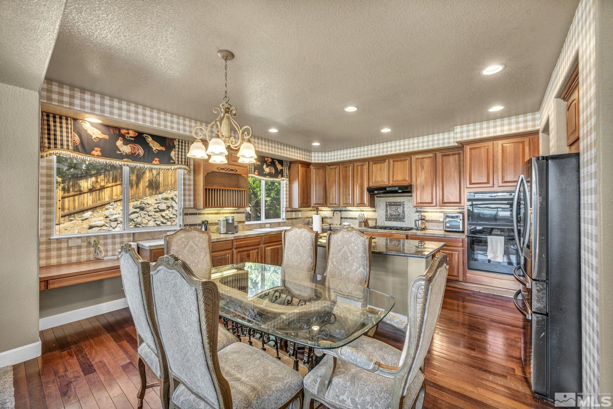 2713 Robb Drive Reno, NV 89523 - Photo 39 of 39 a dining room with furniture a chandelier and wooden floor