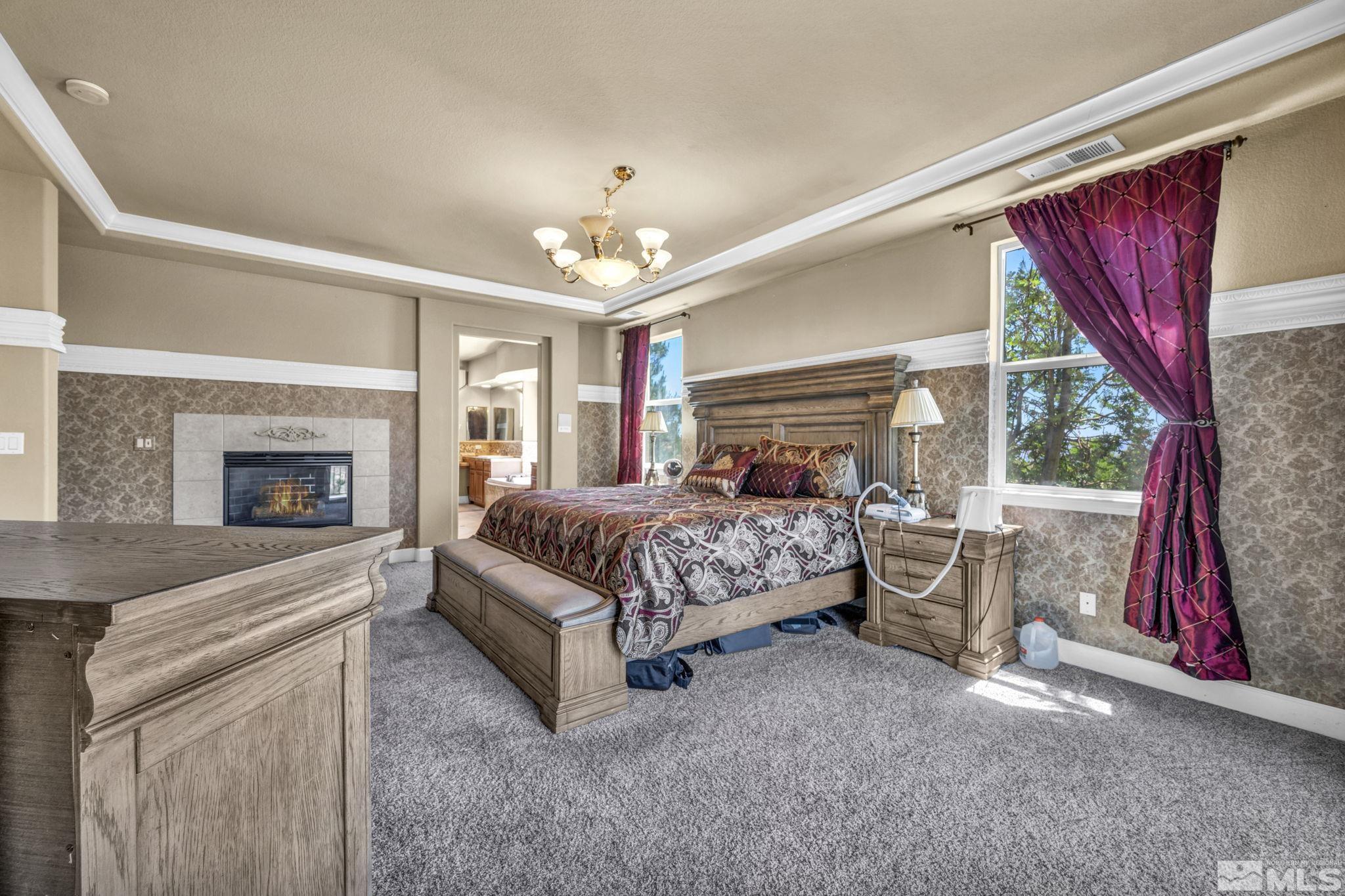 2713 Robb Drive Reno, NV 89523 - Photo 6 of 39 a bedroom with a large bed and a fireplace