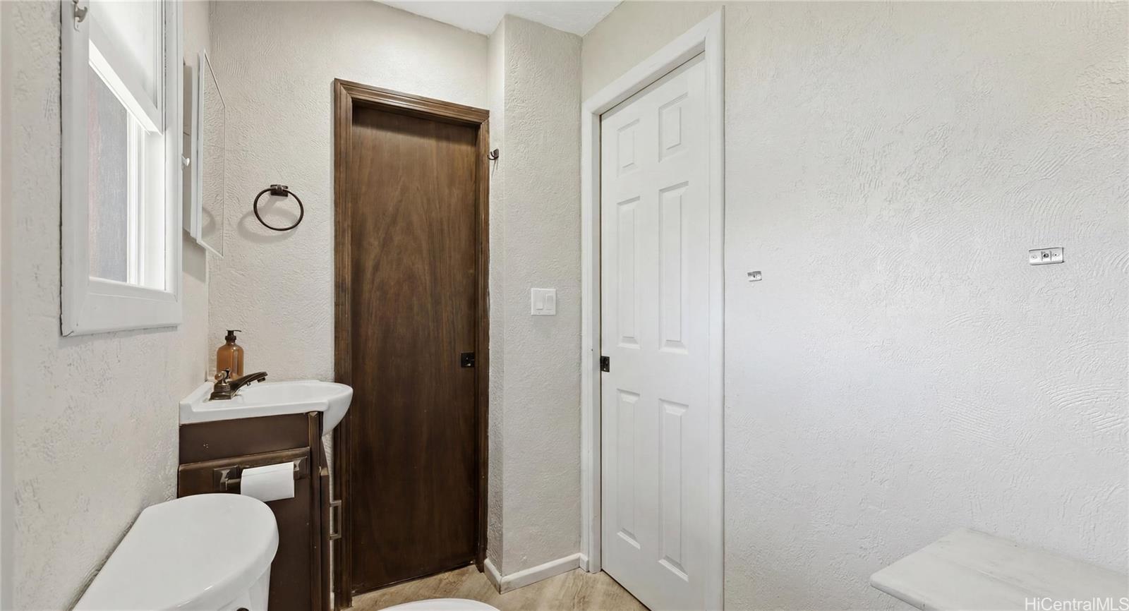 91-779 Fort Weaver Road Ewa Beach, HI 96706 - Photo 13 of 25 Full bathroom off the garage with direct backyard access, perfect for showering after swimming in the pool.
