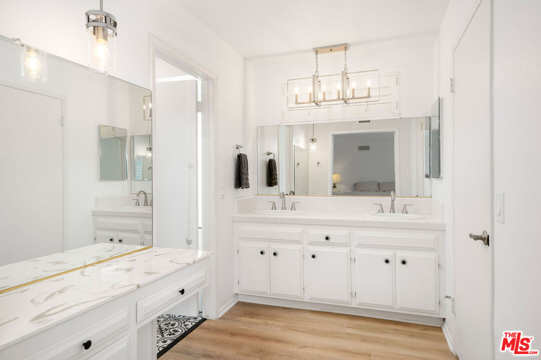 882 West 17th Street Upland, CA 91784 - Photo 11 of 27 a bathroom with a sink double vanity granite tub shower and a mirror