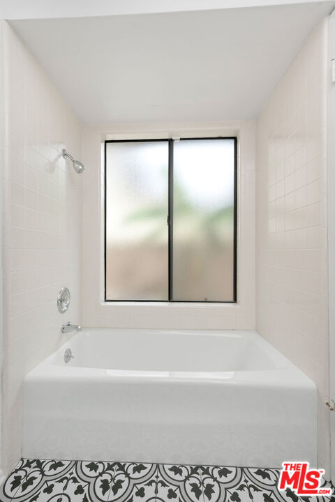 882 West 17th Street Upland, CA 91784 - Photo 12 of 27 a bathroom with a bathtub and a shower