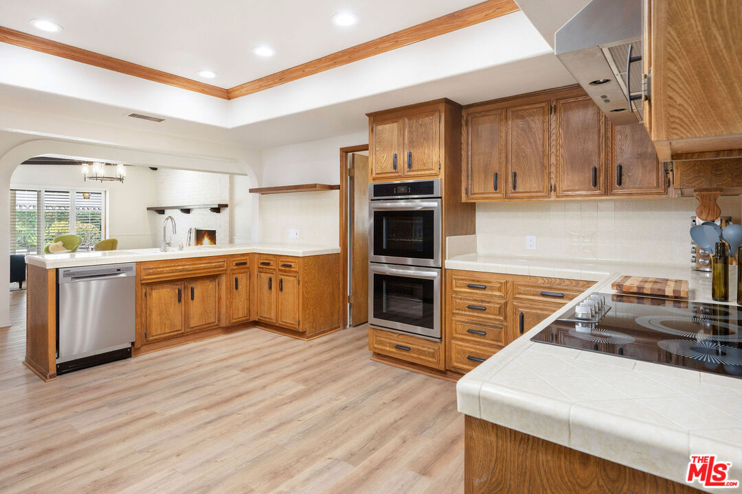 882 West 17th Street Upland, CA 91784 - Photo 13 of 27 a kitchen with stainless steel appliances a sink and a stove top oven