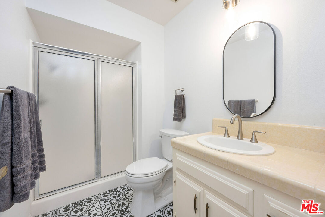 882 West 17th Street Upland, CA 91784 - Photo 19 of 27 a bathroom with a toilet sink and mirror