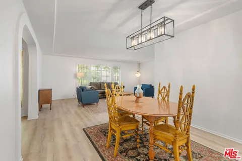 a view of a dining room with furniture wooden floor and a chandelier