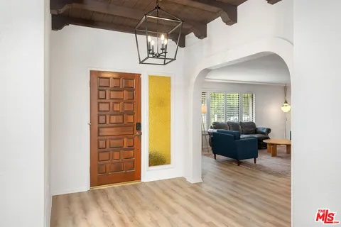 a view of a livingroom with wooden floor and furniture