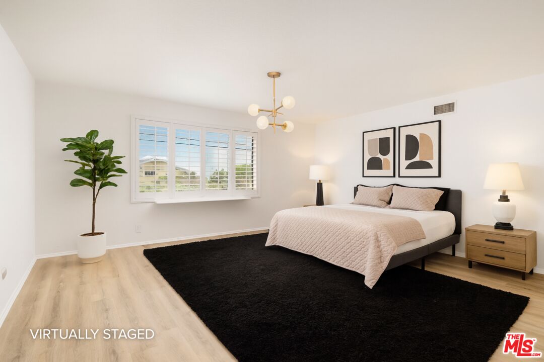 882 West 17th Street Upland, CA 91784 - Photo 9 of 27 a bedroom with a bed and a window