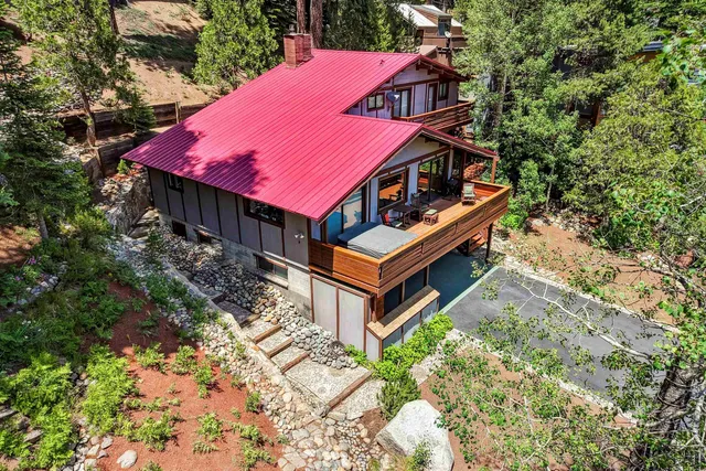 an aerial view of a house with balcony and trees