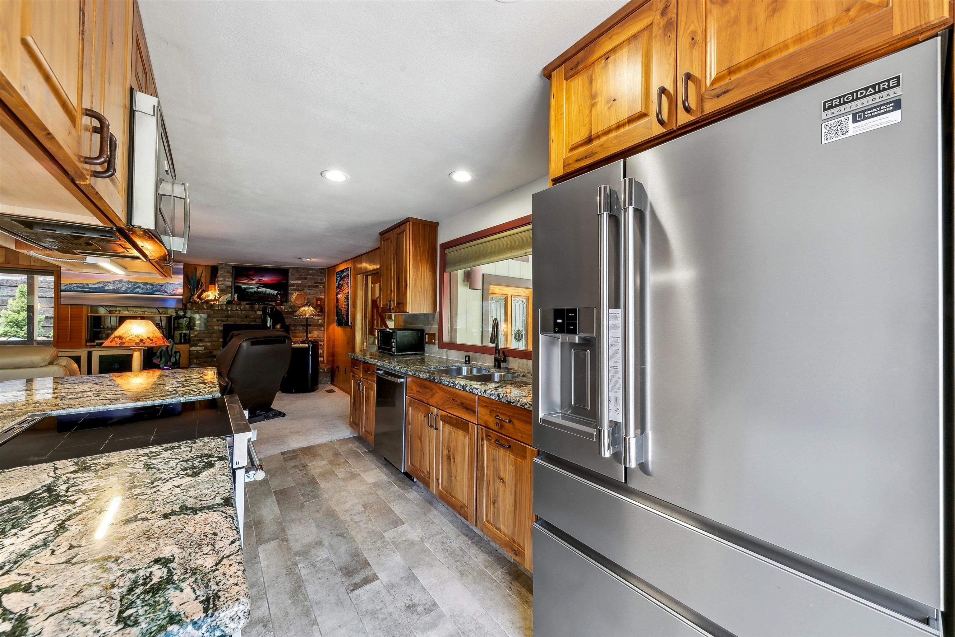 720 Olympic Vly Road Olympic Valley, CA 96146 - Photo 12 of 28 a kitchen with stainless steel appliances granite countertop a refrigerator a stove and a sink
