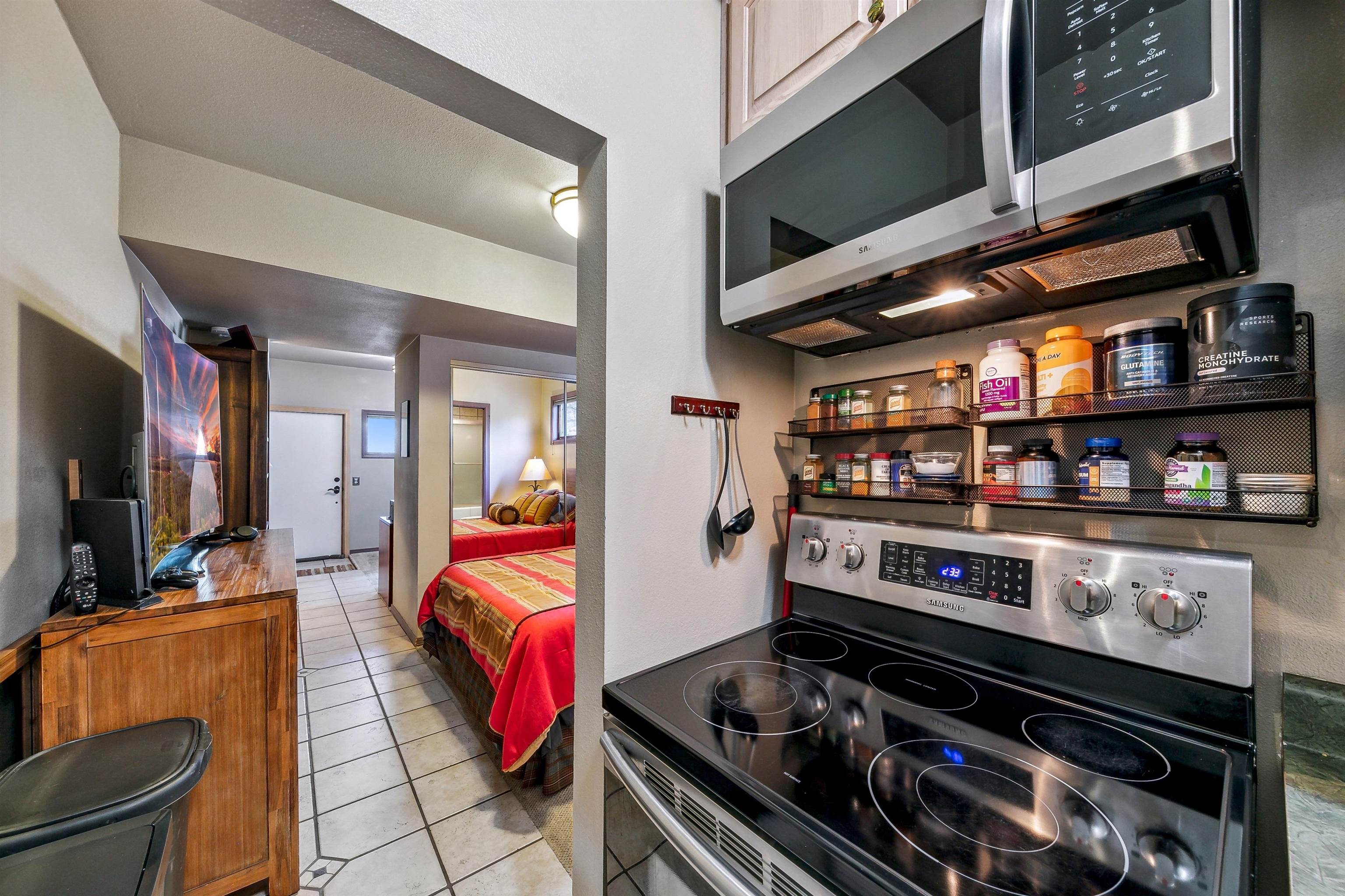 720 Olympic Vly Road Olympic Valley, CA 96146 - Photo 27 of 28 a kitchen with stainless steel appliances granite countertop a stove and a microwave
