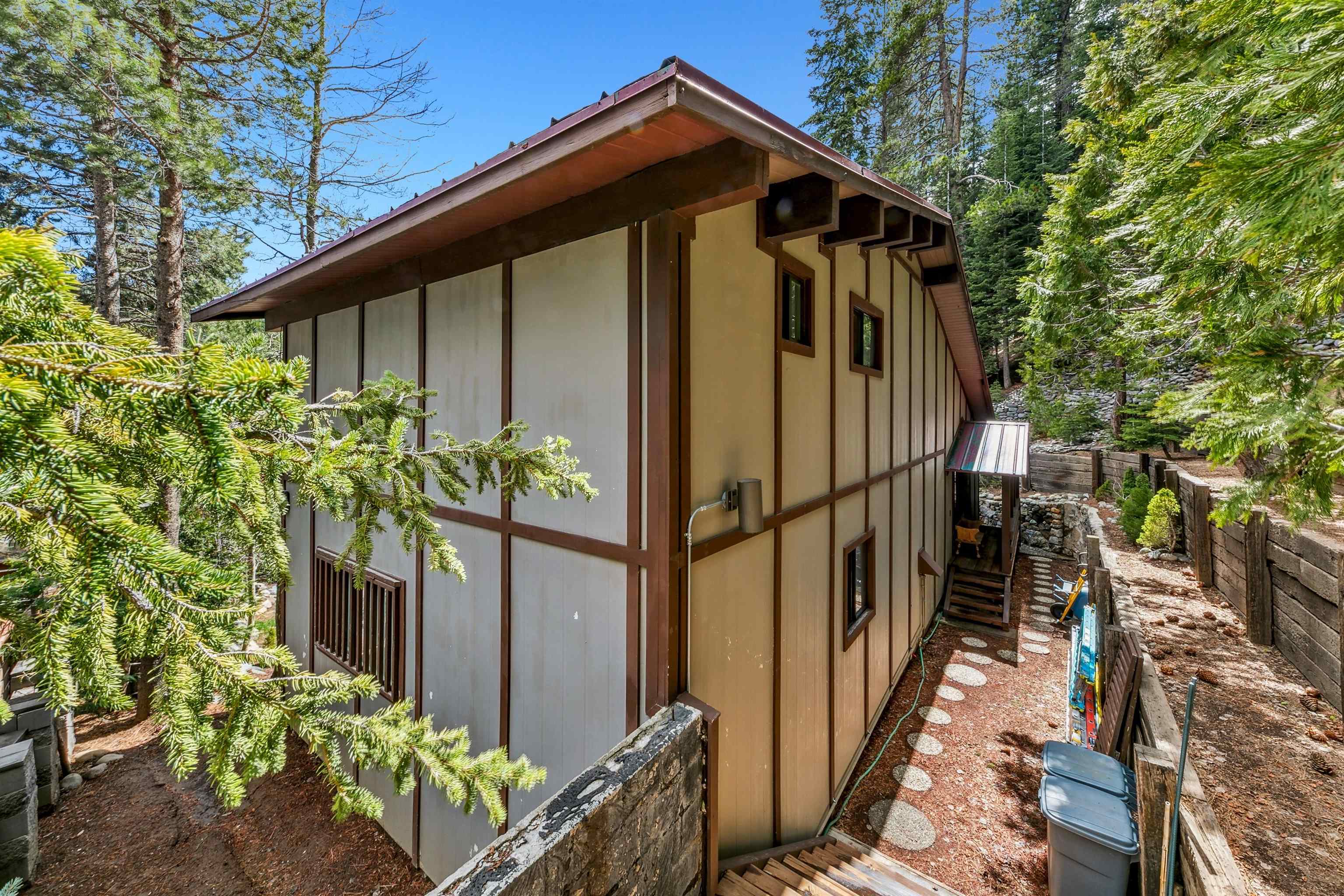 720 Olympic Vly Road Olympic Valley, CA 96146 - Photo 7 of 28 a yellow house with trees in front of it