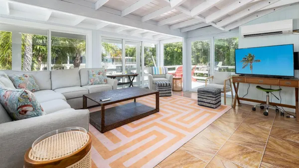 a living room with furniture and a floor to ceiling window