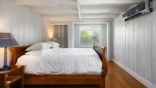 a bedroom with a bed and a window