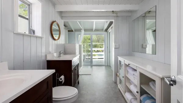 a bathroom with a toilet a sink and a mirror