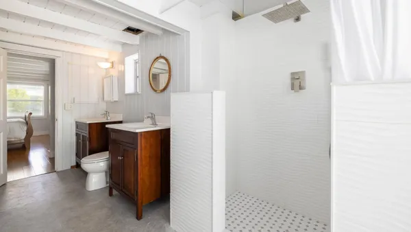 a bathroom with a toilet a sink and a mirror