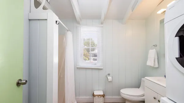 a white toilet sitting next to a bathroom sink