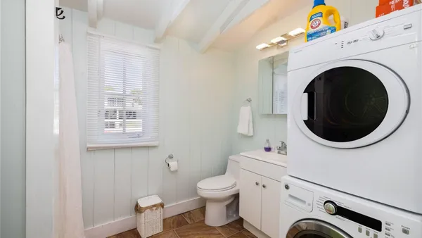 a bathroom with a toilet a sink and a mirror